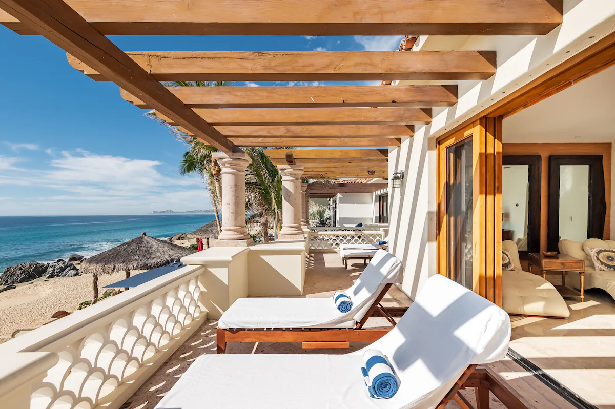 Grandparents and grandchildren relaxing together in a luxury villa living room with ocean views in Cabo