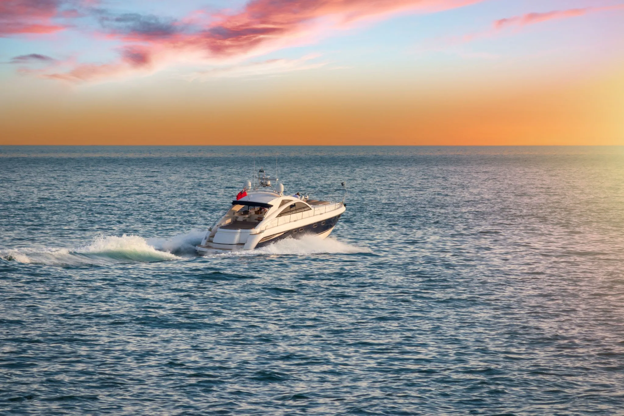 Luxury yacht charter sailing at sunset in Los Cabos, perfect for corporate networking