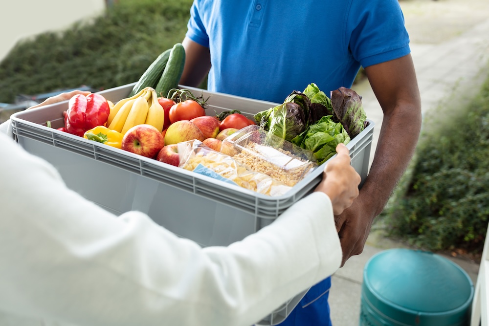 A person receiving grocery delivery. 