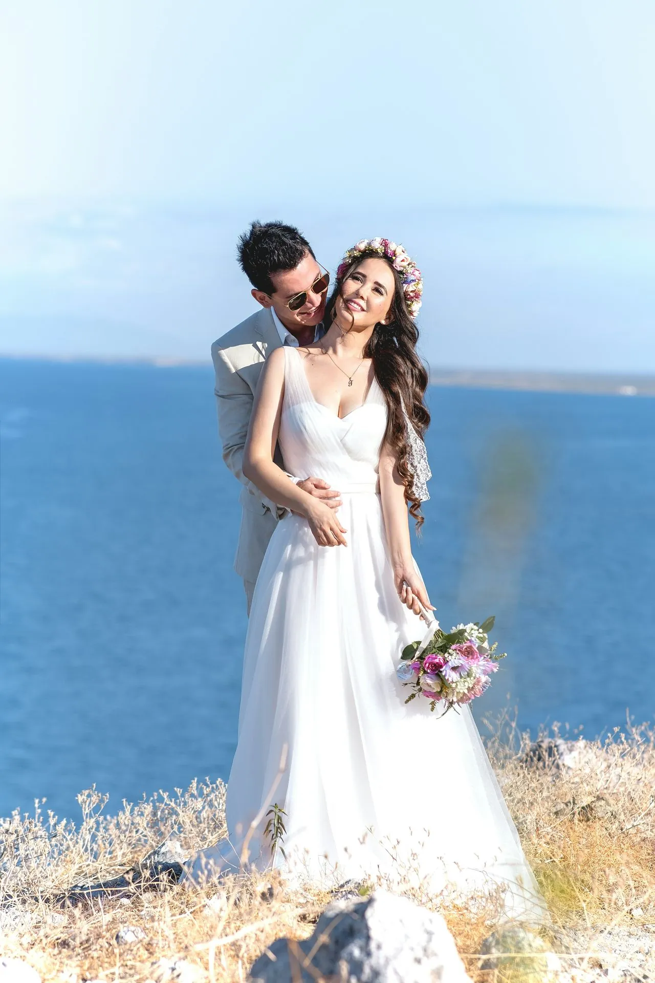 Couple on an ocean-view cliff at a private villa wedding in Los Cabos